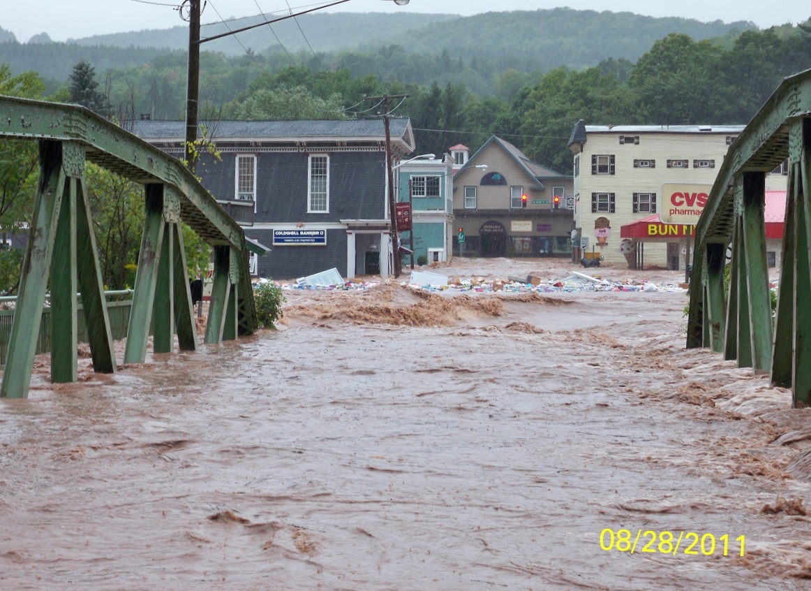 Image from 2011 of flooding in Margaretville, NY. Floodwaters are covering bridge and have inundated Main and Bridge Streets.