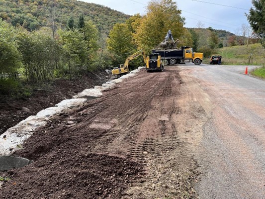 Cloves Clove SL 4.62 Bank Stabilization project. Image shows view upstream from edge of the roadway toward a newly installed stacked rock wall.